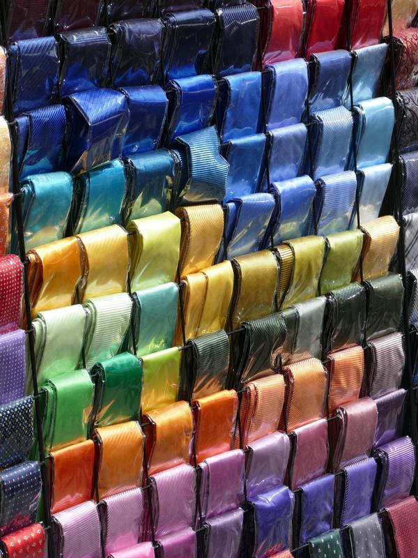 Colourful ties for sale, carefully wrapped in plastic.