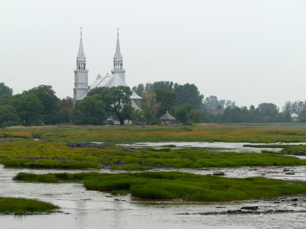 A church seen over the salt flats of the St. Lawrence