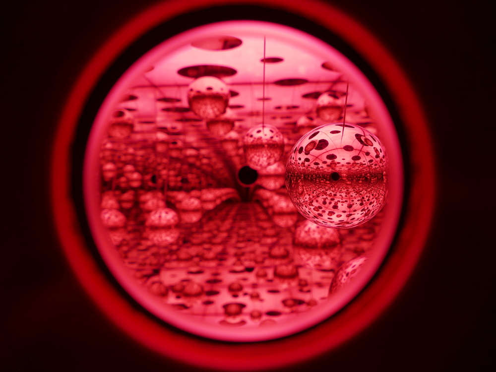 mirror balls reflected in more mirrors with very pink lighting