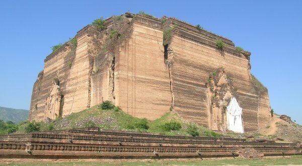 Massive block of orange stone, incomplete and earthquake-fractured temple