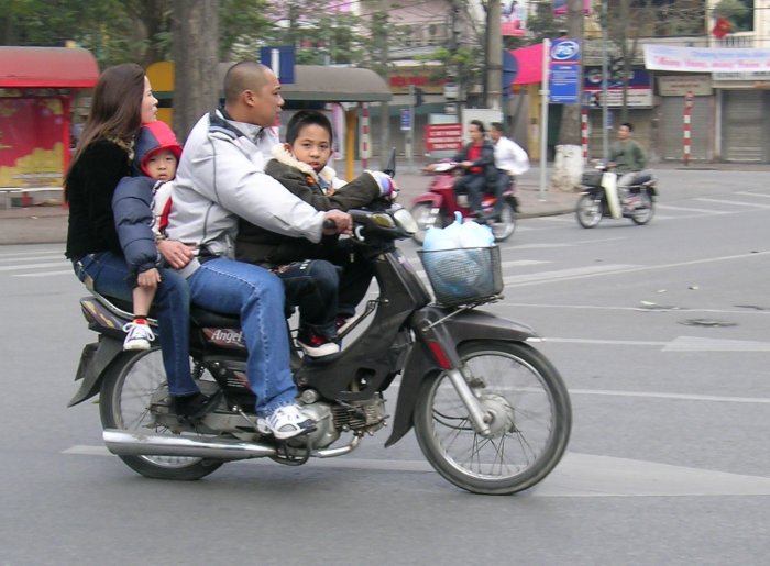 Two parents, two children, 100cc motorcycle.