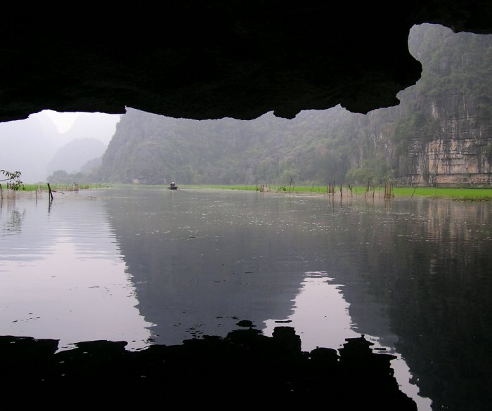 Exiting a cave by rowboat at Tam Coc