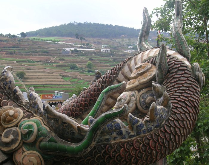 Terraced hills behind a ceramic dragon.