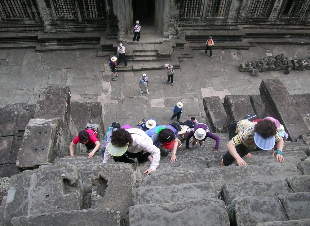 Climbing the stairs at Angkor Wat